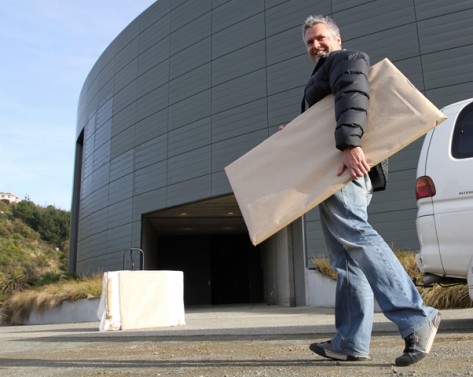 artexpo15 Nic Foster carries artwork into the Trafalgar Centre for this weekend’s Nelson Art Expo. Photo: Andrew Board.