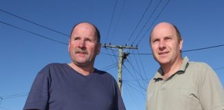 Elliot St residents Geoff Morrissey, left, and Neil Deans want the overhead lines on Elliot St to be put underground. Insert: Spacers have been used to keep the lines apart. Photos: Andrew Board.