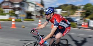 Nelson cyclist Robbie Hill takes a corner during the race around the Cathedral on Sunday. Insert: Cyclists race past the Cathedral. Photos: Phillip Rollo.