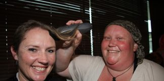 Monique Nicoll of Nelson has the last of her blonde hair shaved off by friend Michelle Williamson at the Nelson Suburban Club on Friday night. Photos: Sinead Ogilvie.