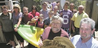 Prince Albert Hotel regulars Chris Gunn and Pat Wilson, right, with the challenge shield they created and one of the kayaks they donated to the special needs department at Waimea College. Photo: Andrew Board.