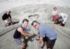 Sandcastle best in NZ? Julie Flintoff, Gaye, Graeme and Stella Bloomfield, 6, with Brian Flintoff after completing their entry into the Hyundai sandcastle competition on Tahunanui Beach on Saturday. Photo: Sinead Ogilvie.