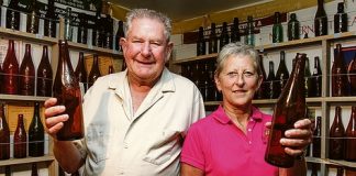 Lindsay Jukes will be showcasing his bottle collection at this weekend’s Blokes in Sheds trail. He is pictured with organiser Marg Palmer of Life Education. Photo: Phillip Rollo.
