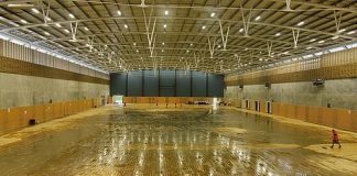 Staff work at mopping up the flood-damaged floors at Saxton Stadium on Monday morning. Photo: Phillip Rollo.