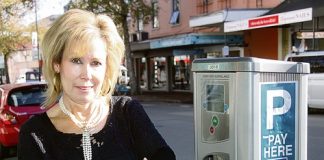 Jays Fashions owner Karen Jordan with one of the parking meters she’d like to see go.