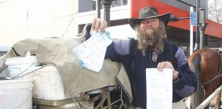 Lewis Stanton with some of his parking tickets and a summons to appear in court. Photo: Sinead Ogilvie.