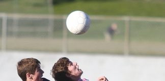 Richmond's Danny Ross heads the ball in front of a Nelson College player at Broads on Saturday. Photo: Andrew Board.