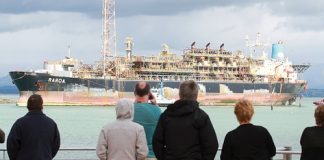 Crowds at Fisherman’s Wharf watch the oil storeage ship Raroa enter Port Nelson on Monday morning. Photo: Andrew Board.