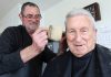 Larry’s been cutting Les’ hair for 50 years Barber Larry Sutherland cutting Les Sangster hair last week, 50 years after he cut it for the first time. Photo: Andrew Board.
