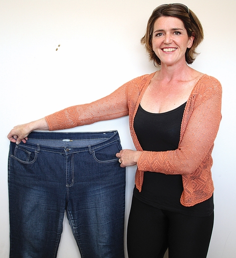 julie8625 Julie Redwood after losing 50kg and with her old jeans. Photo: Andrew Board.