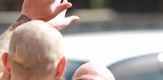 HIGH FIVE: Duane Hughes high fives another “shaved head” after having his beard and head shaved for the Nelson Hospice on Sunday. Photo: Andrew Board.