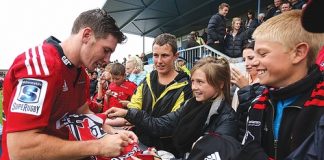 Crusaders player Colin Slade signs autographs for fans at Sportspark Motueka on Friday night. Photo: Phillip Rollo.
