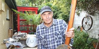 Nelson man, John Dixon, with one of his slide guitars, made out of an old ceiling fan. John makes his guitars out of hub caps and cigar boxes as well. Photo: Andrew Board.