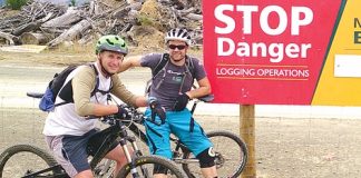 Nelson Mountain Bike Club members Glen Hersey, left, and Jamie Bate by one of the warning signs notifying riders about the closure of tracks.