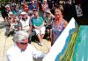 Stephanie Buck listens to Doug Hill play the Richmond street piano at the piano’s opening in Sundial Square. Two community pianos are now coming to Nelson. Photo: Simon Bloomberg.