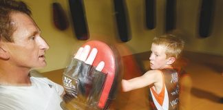 Scott Gibbons holds the pads for his son Oliver at the Victory Boxing Club on Friday night, when the club held its first “father/son” evening. Photo: Evan Barnes/www.shuttersport.co.nz.