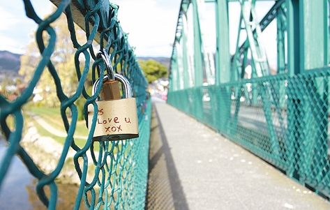 padlocks (46) Love locks attached to the wire fence on the Collingwood St bridge. The number of locks has been increasing in recent months. Photos: Andrew Board.