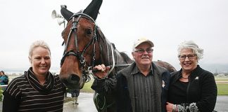 The Brian Hill-trained Sunchita and Blair Orange winning the Tommy Behrns Handicap Trot at the Nelson Harness Racing Club's winter meeting at Richmond Park on Sunday. Right: Owner-trainer Brian Hill and his daughter Kristie and wife Cheryl with their star trotter Sunchita after winning the Tommy Behrns Handicap Trot. Photos: Simon Bloomberg.