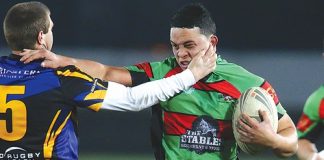 Tamaira Raurimu-Carew of the Rabbits fends off a Wanderers tackler during its 38-36 win at Trafalgar Park. Photo: Evan Barnes/Shuttersport.