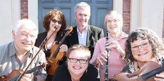 Car Company owner Shane Drummond and Breeze announcer Briffni O'Rourke, centre, with symphony orchestra members from left; Richard Mackay, Robin Sanders, Valerie Towse and Christine Foote. Photo: Andrew Board.