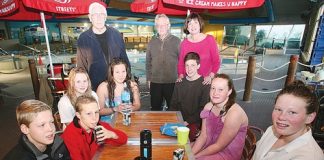 Tasman Swim Breakfast Club parents and grandparents, from left, Garry Smith, George McKenzie and Lisa Dunn, with some of the club’s age group swimmers at breakfast at the ASB Aquatic Centre last Thursday. Photo: Simon Bloomberg.