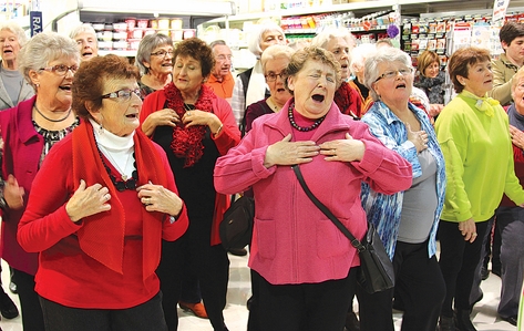 Flash Mob Pam Shaw, centre, gets into the music as the over 60s choir Off Their Rockers converged on Fresh Choice Nelson for a much appreciated flash mob. Photo: Jessie Johnston.