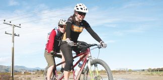 Brenda Clapp rides her tandem mountainbike with Heather Bates on board during a training ride on Sunday. Photo: Simon Bloomberg.