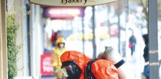 Firefighters from the Nelson’s Fire Brigade’s hazardous materials response team collect the contaminated clothing from outside a Queen St store, during last week’s chemical scare in Richmond. Photo: Simon Bloomberg.