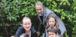 Brook Waimarama Sanctuary Trust chairman Dave Butler with Macey, Mia, Jacob, Thomas, Malachi and Oscar, as they install the first fence post at the Brook sanctuary on Saturday. Photo: Jessie Johnston.