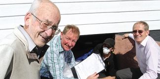 Atawhai resident Lance Langdon watches his rented home get insulated by Absolute Energy’s Craig Hibbs. With them is Nelson MP Nick Smith and Canterbury Community Trust’s Bill Dahlberg. Photo: Andrew Board.
