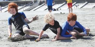 Hogan Ward captures the flag in the beach sprints on Saturday, during the Nelson Surf Life Saving Club open day. Photo: Jessie Johnston.
