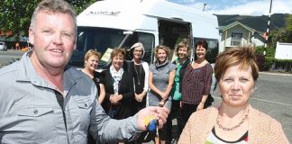 Discover NZ Campervan owner, Tony Terrell, donated the use of a campervan for ten days around the South Island to the Walk with Us charity auction. Getting the keys is winner of the auction, June Ferguson, as trustees from Walk with Us watch on. Photo: Andrew Board.