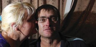 Richmond man Mike Corkill get a kiss from his wife Julie-Ann after hearing that he may not live to see Christmas. Photo: Andrew Board.