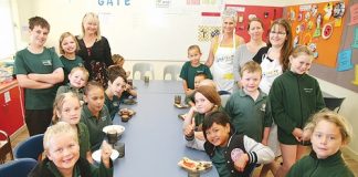 Birchwood School’s Breakfast Club coordinator, Janice Johnson, back left, with parent helpers and pupils at breakfast before school last Friday. Photo: Simon Bloomberg.