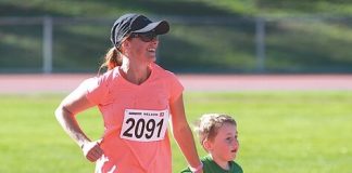 Nelson's Jacqui Jones running the last 100 metres of her half marathon with a young supporter. Photo: Andrew Board.