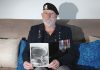 Atawhai man Neil Balloch with a photo of the nuclear explosion he witnessed when he was in the Navy during the 1950s. Photo: Andrew Board.