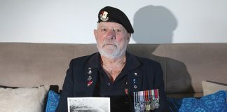 Atawhai man Neil Balloch with a photo of the nuclear explosion he witnessed when he was in the Navy during the 1950s. Photo: Andrew Board.